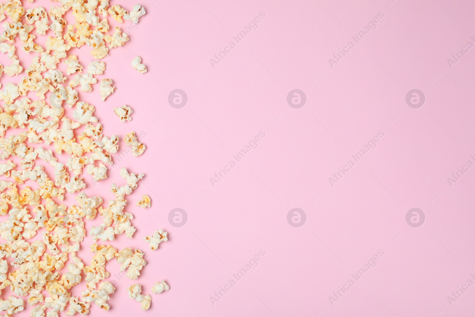 Photo of Flat lay composition with tasty popcorn and space for text on color background