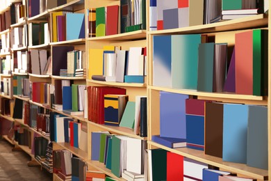 Collection of different books on shelves in library
