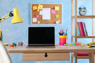 Photo of Modern workplace with laptop on wooden desk