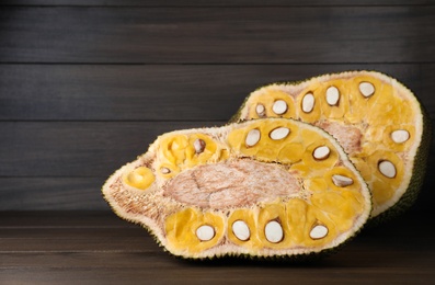 Delicious cut exotic jackfruit on wooden table