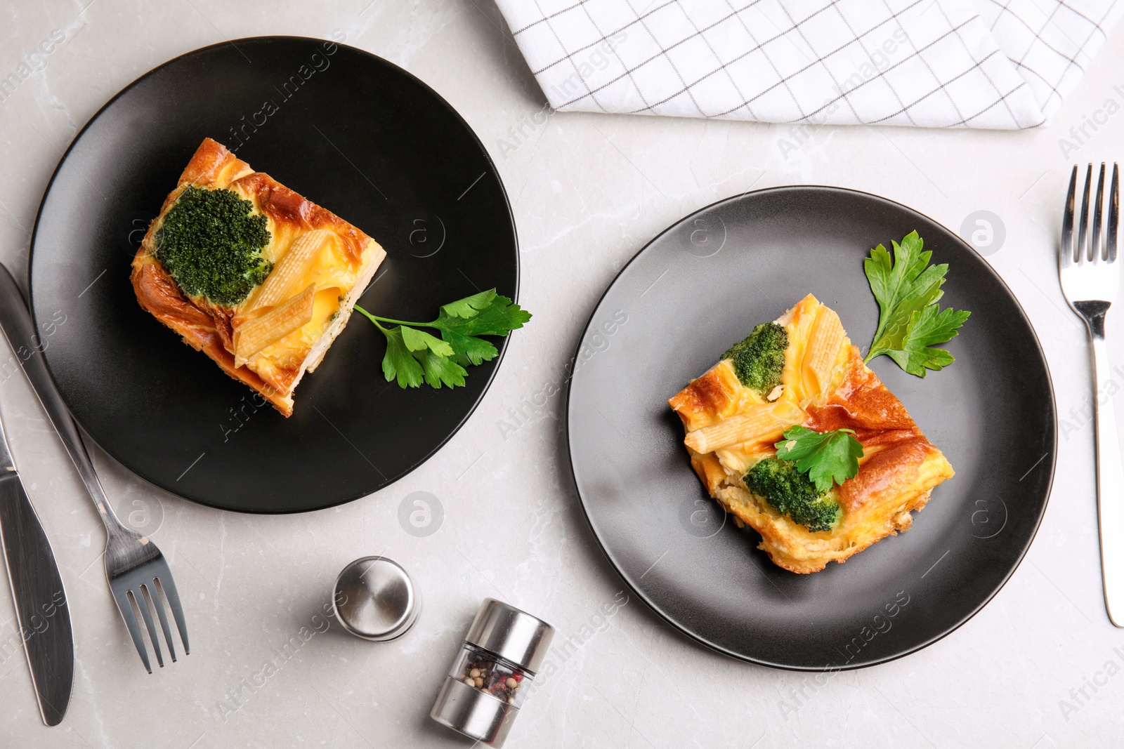 Photo of Tasty broccoli casserole served on grey marble table, flat lay