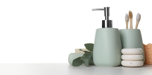 Bath accessories. Different personal care products and eucalyptus branch on table against white background. Space for text