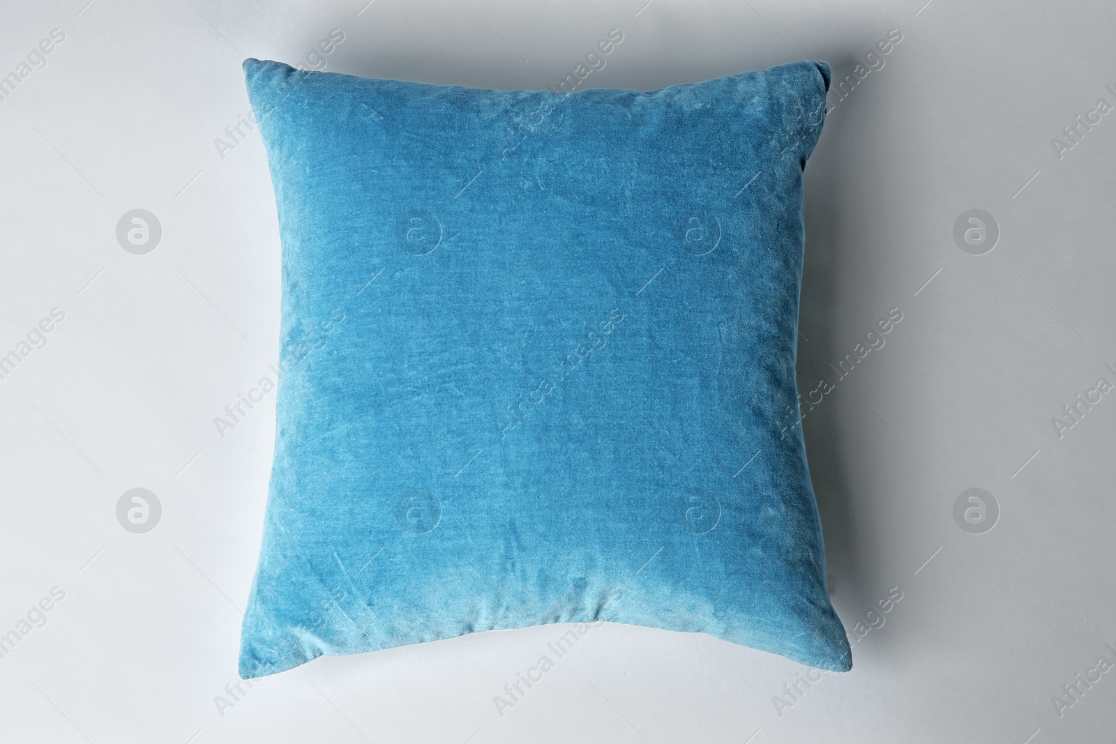 Photo of Soft decorative pillow on light background