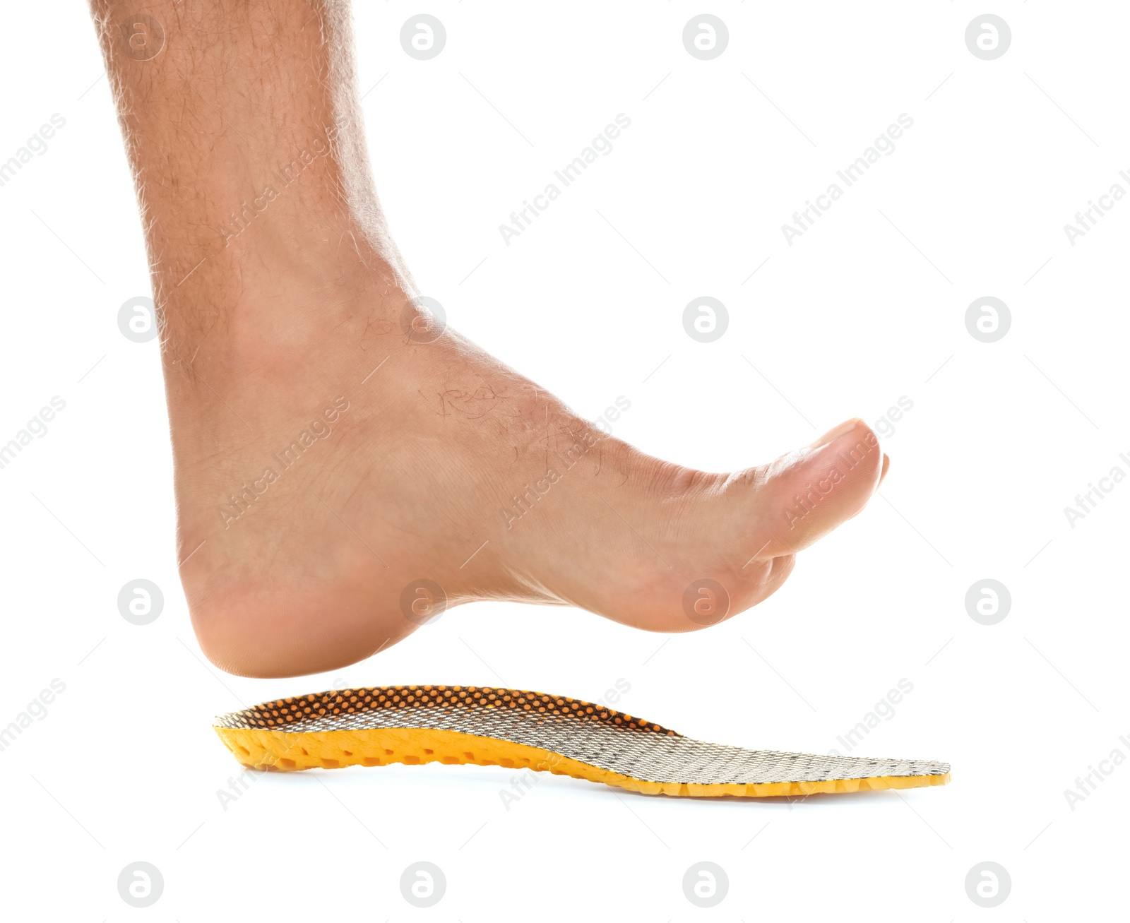 Photo of Man fitting orthopedic insole on white background, closeup. Foot care