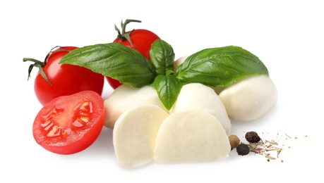 Photo of Delicious mozzarella with tomatoes and basil leaves on white background