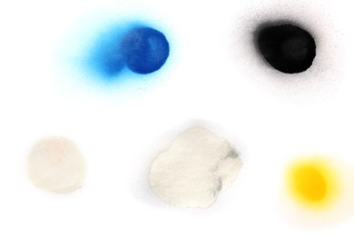 Photo of Spots drawn by different spray paints on white background