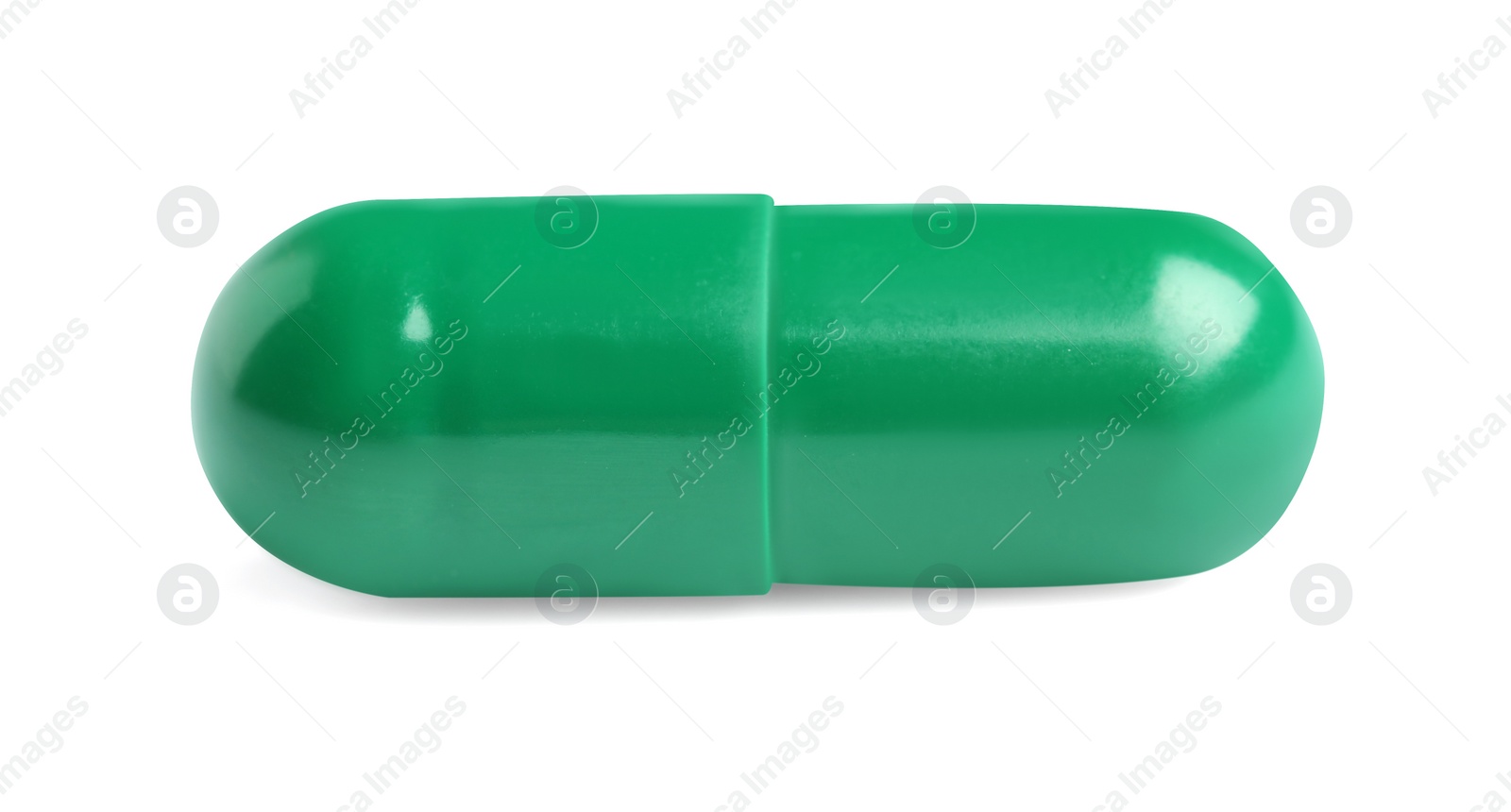 Photo of One green pill on white background. Medicinal treatment