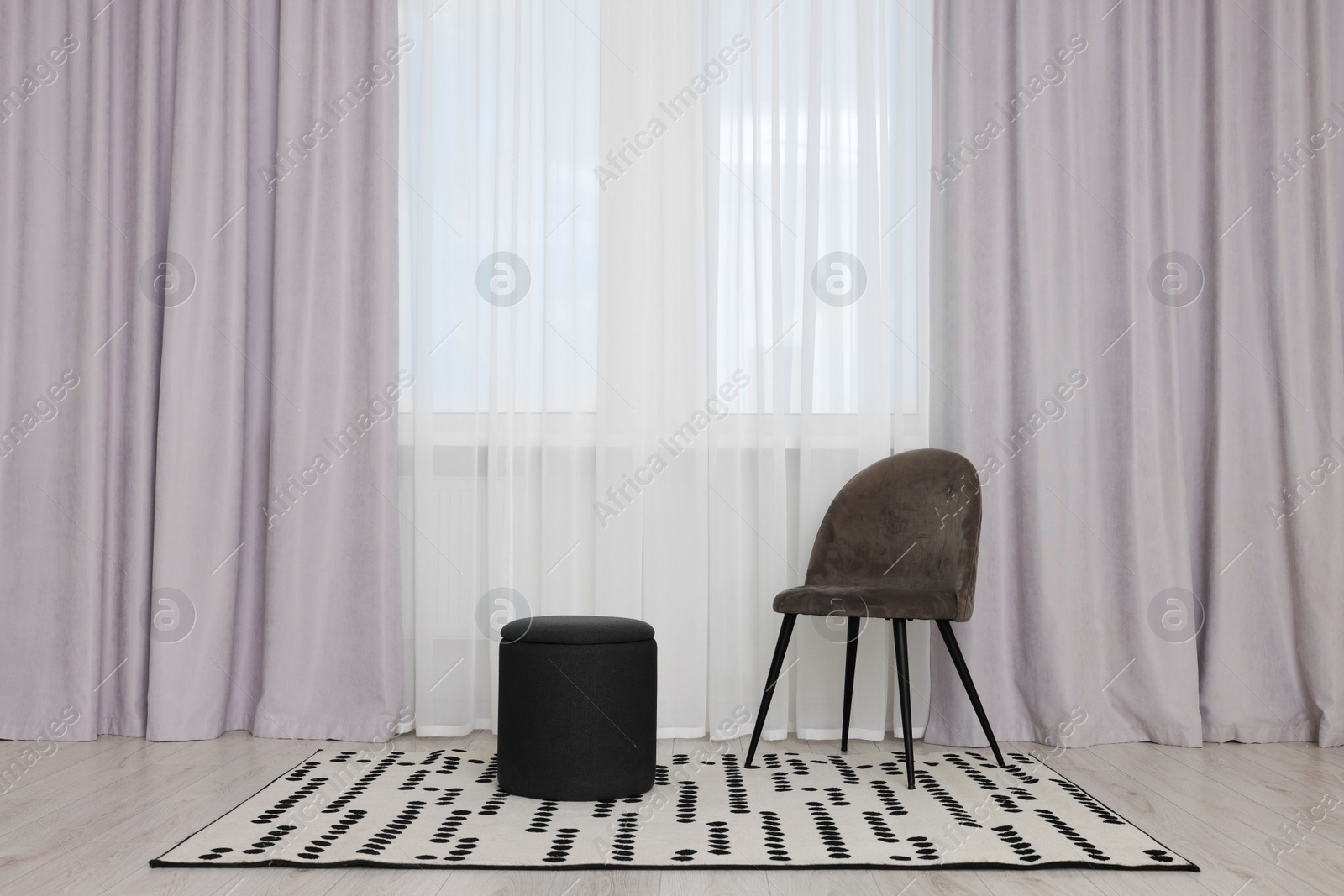 Photo of Stylish room interior with comfortable chair and beautiful window curtains. Space for text