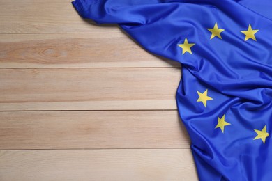 Flag of European Union on wooden table, top view. Space for text