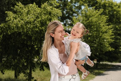 Photo of Happy mother with her daughter having fun in park