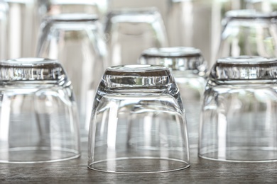 Photo of Set of empty glasses on wooden table, closeup