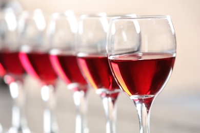 Photo of Glasses with delicious red wine, closeup