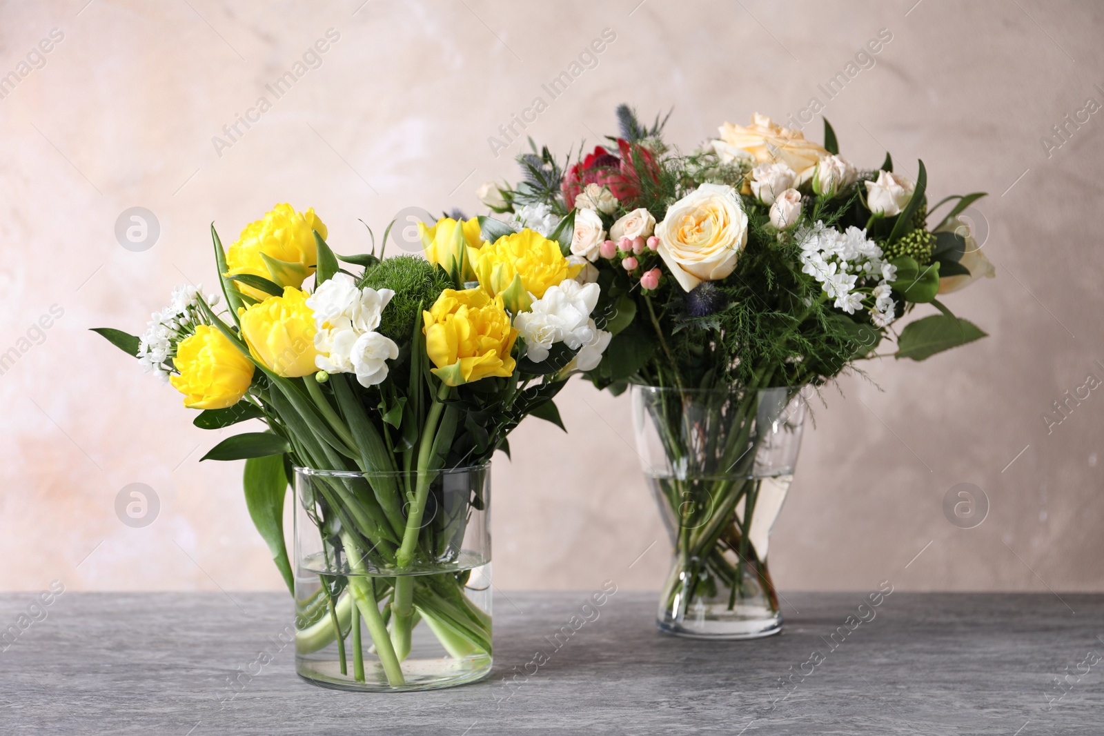Photo of Beautiful bouquets with fresh flowers on grey table