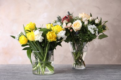 Beautiful bouquets with fresh flowers on grey table