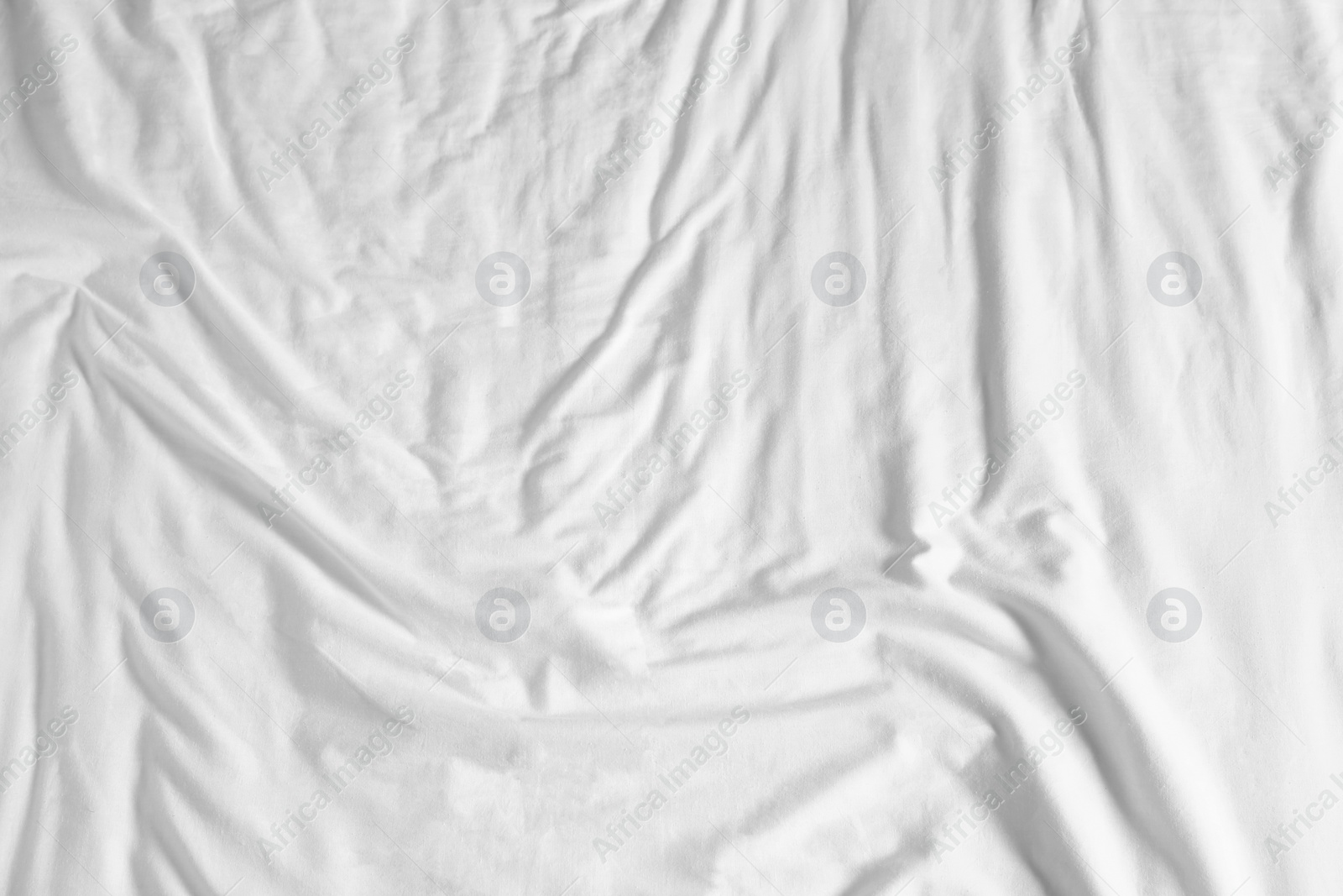 Photo of Crumpled white fabric as background, top view