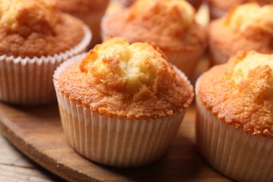 Delicious sweet muffins on wooden table, closeup