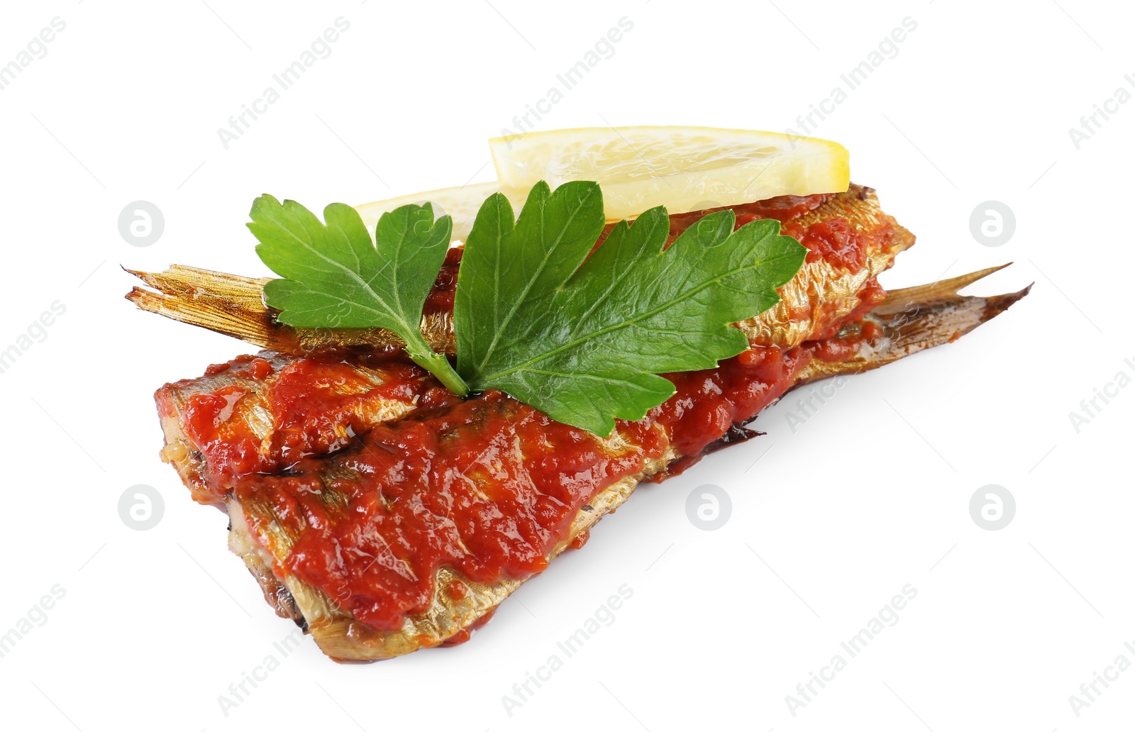 Photo of Tasty canned sprats with tomato sauce, parsley and lemon isolated on white
