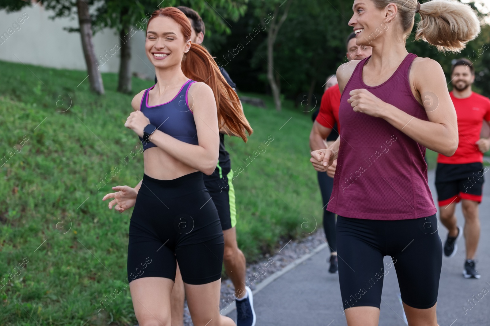 Photo of Group of people running outdoors. Active lifestyle