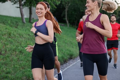 Photo of Group of people running outdoors. Active lifestyle