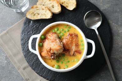 Photo of Tasty cooked rabbit meat with sauce served on grey table, top view