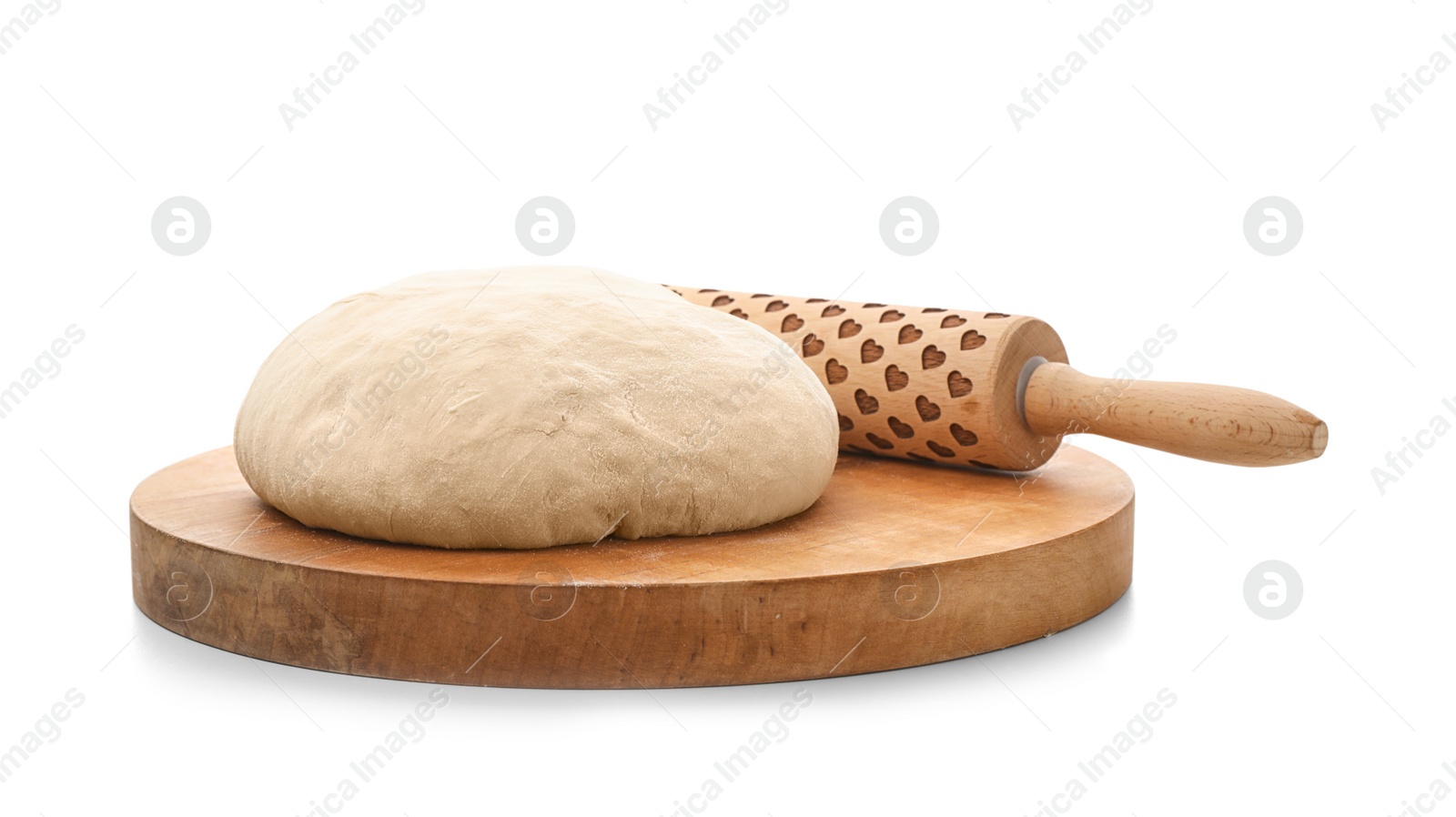 Photo of Wooden board with raw wheat dough and rolling pin on white background