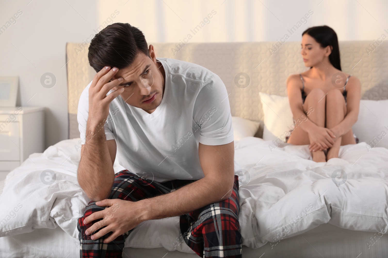 Photo of Unhappy couple with relationship problems after quarrel in bedroom