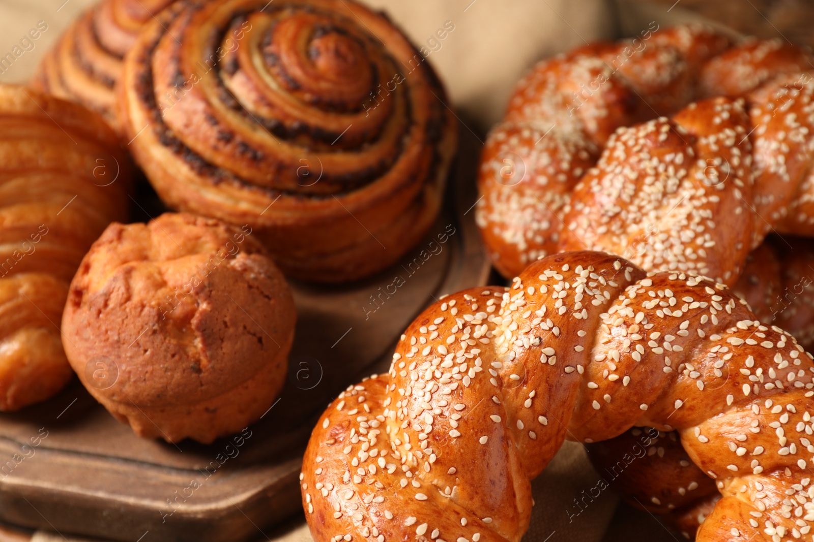 Photo of Different tasty freshly baked pastries on table, closeup view