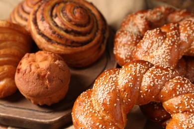 Photo of Different tasty freshly baked pastries on table, closeup view