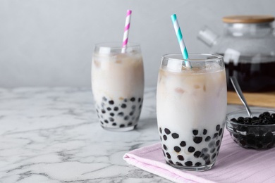 Bubble milk tea with tapioca balls on white marble table. Space for text