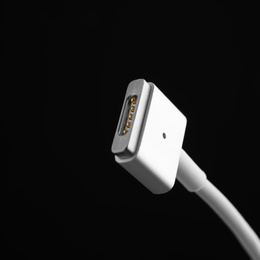 Photo of Charge cable on black background, closeup. Space for text