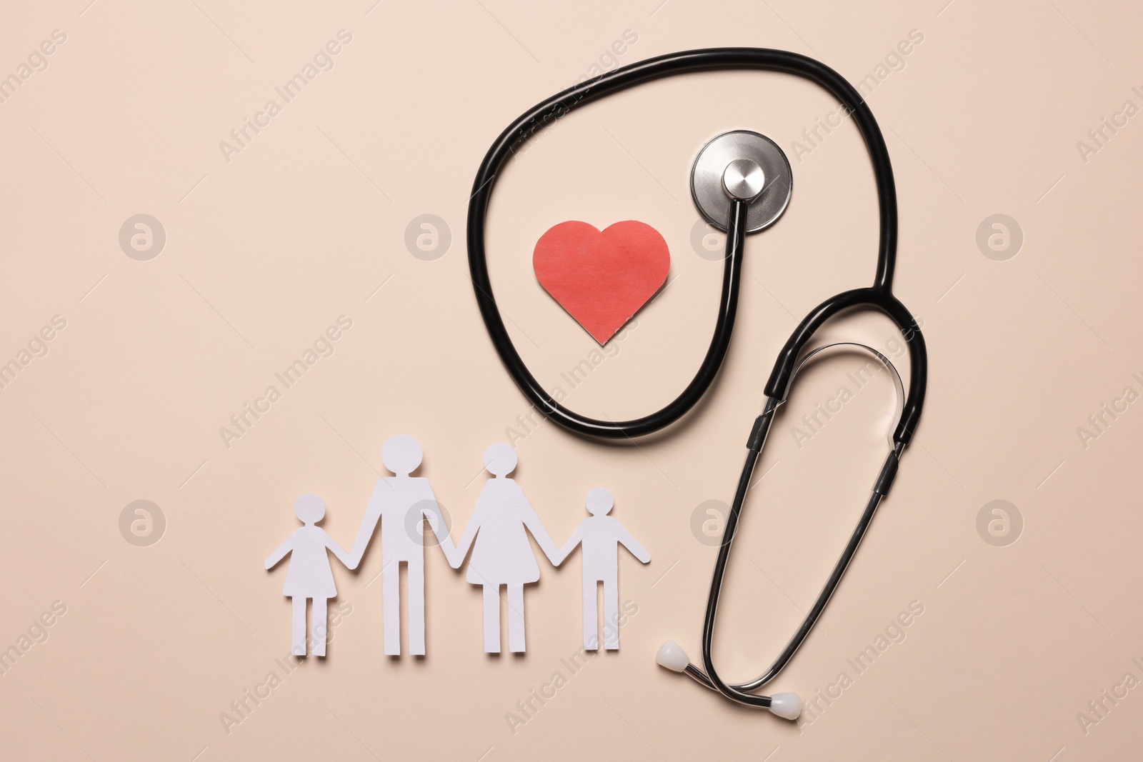 Photo of Paper family figures, red heart and stethoscope on beige background, flat lay. Insurance concept