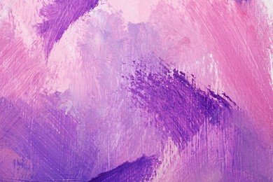 Photo of Beautiful strokes of pink and violet oil paints as background, closeup
