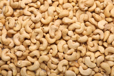 Many tasty cashew nuts as background, top view