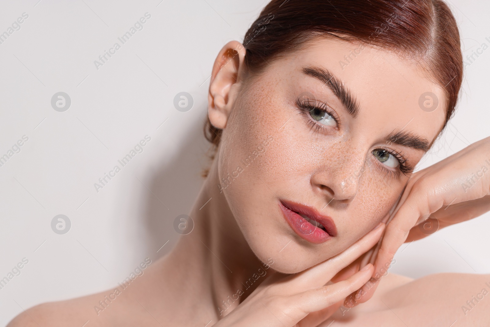 Photo of Portrait of beautiful woman on light background, closeup