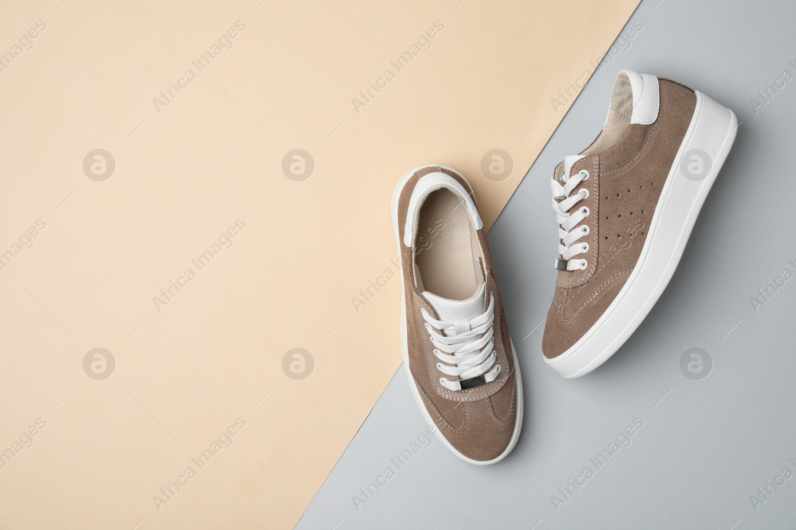 Photo of Stylish brown shoes on color background, flat lay. Space for text