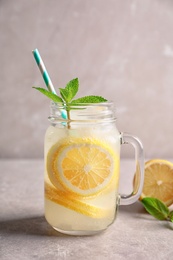 Photo of Refreshing natural lemonade in mason jar on table