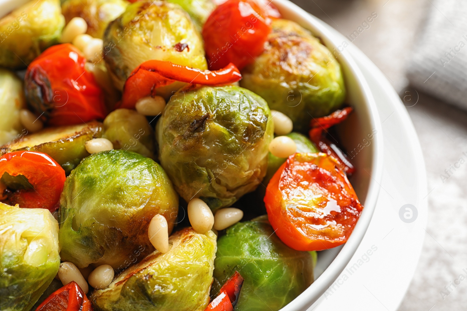 Photo of Bowl of salad with Brussels sprouts on table, closeup