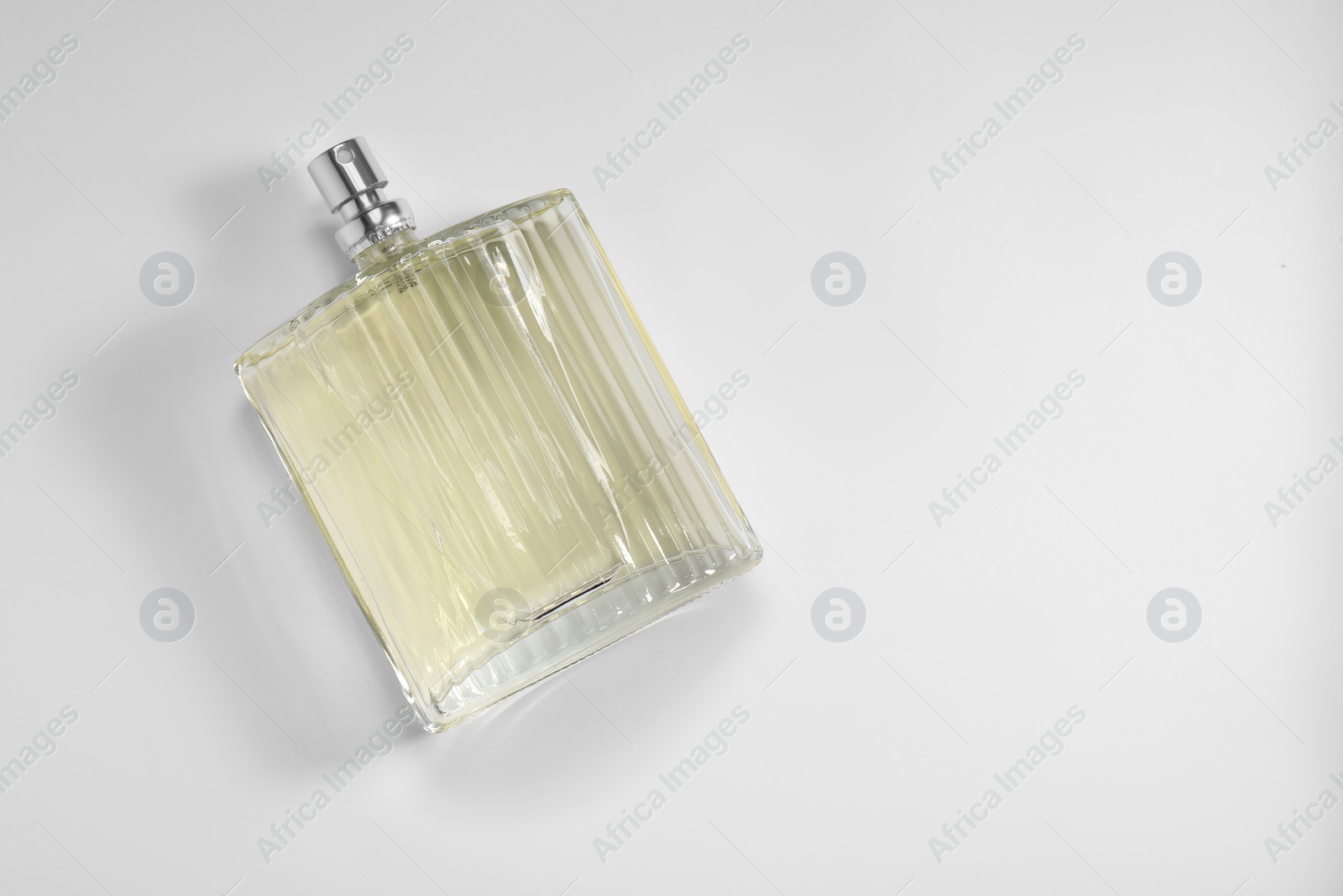 Photo of Luxury men`s perfume in bottle on white background, top view. Space for text