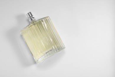 Luxury men`s perfume in bottle on white background, top view. Space for text