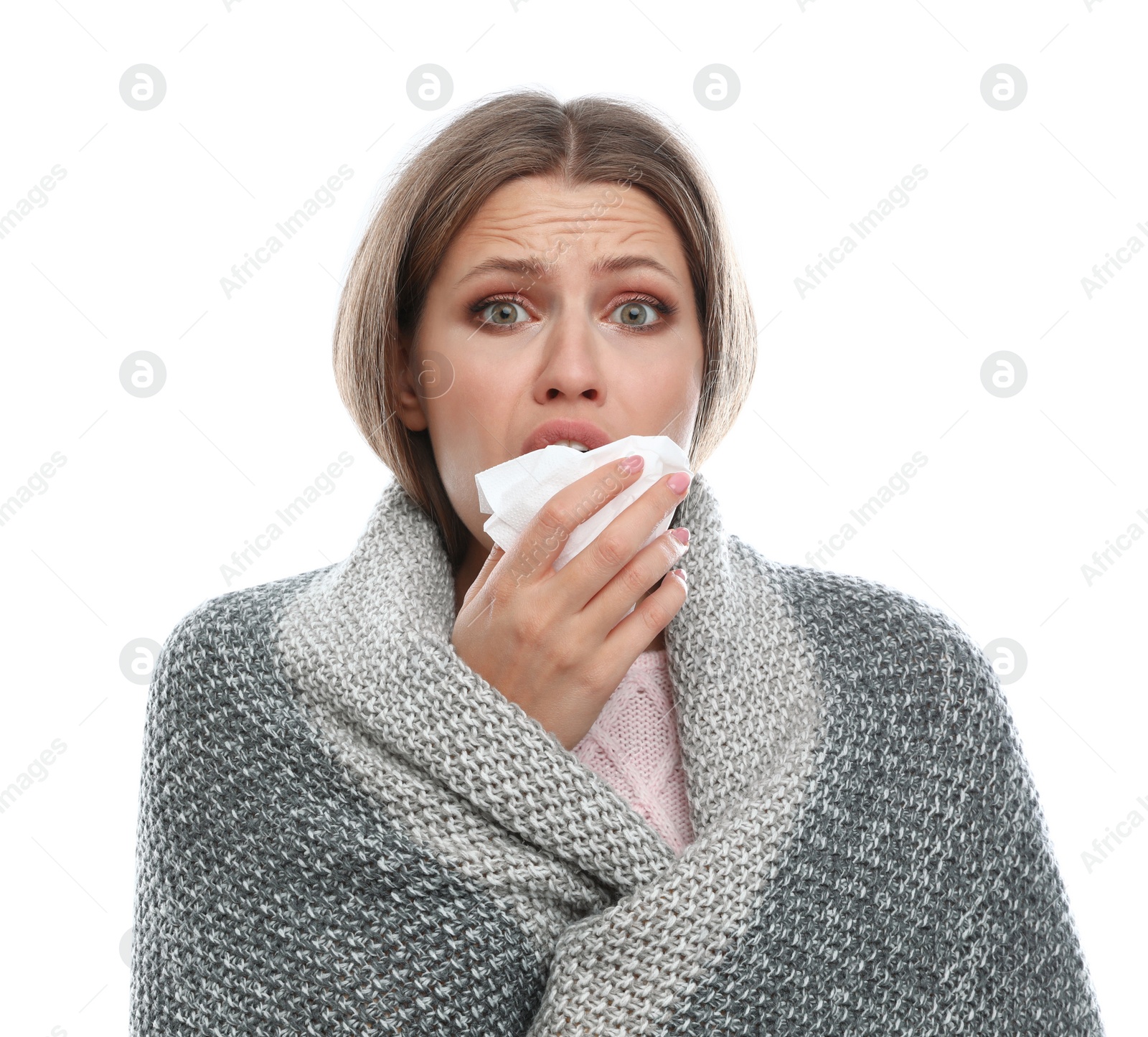 Photo of Young woman wrapped in warm blanket suffering from cold on white background