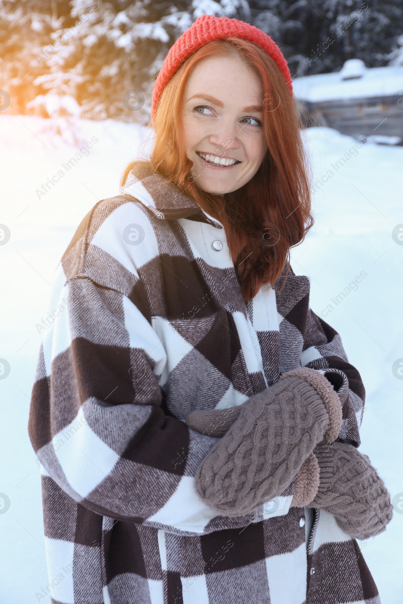 Photo of Portrait of beautiful young woman on snowy day outdoors. Winter vacation