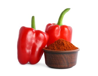 Photo of Fresh bell peppers and bowl of paprika powder on white background