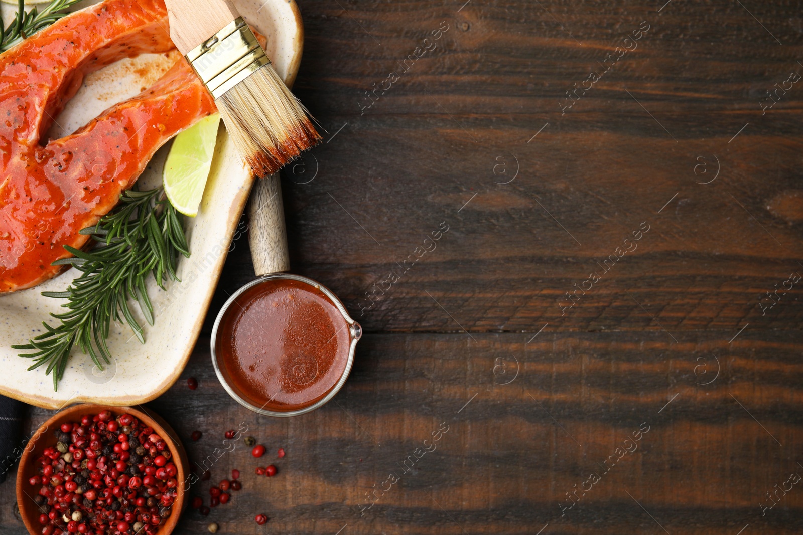 Photo of Fresh marinade, fish and other products on wooden table, flat lay. Space for text