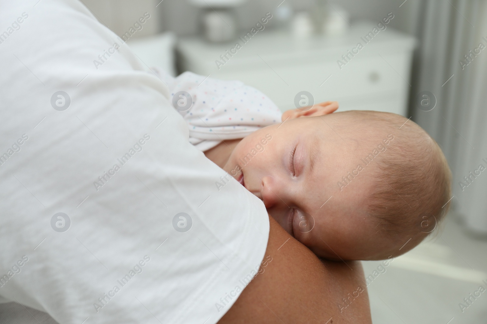 Photo of Father holding his cute sleeping baby at home, closeup