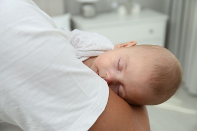 Photo of Father holding his cute sleeping baby at home, closeup