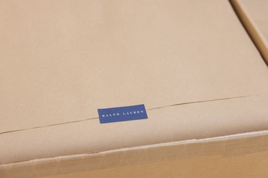 Photo of Leiden, Netherlands - December 6, 2023: Open box with Ralph Lauren garment, closeup