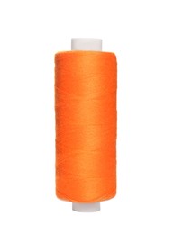 Photo of Spool of orange sewing thread isolated on white