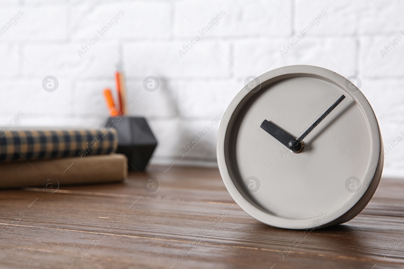 Photo of Modern alarm clock on table indoors. Space for text