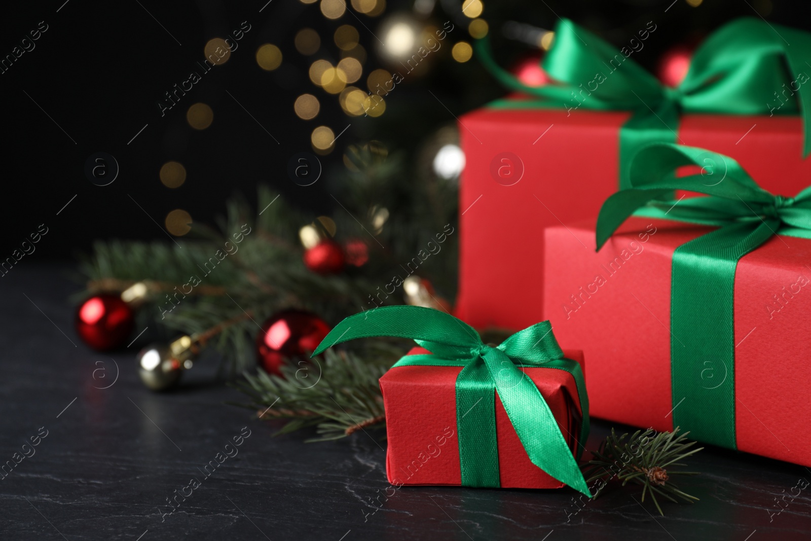 Photo of Gift boxes and Christmas decorations on dark grey table, space for text