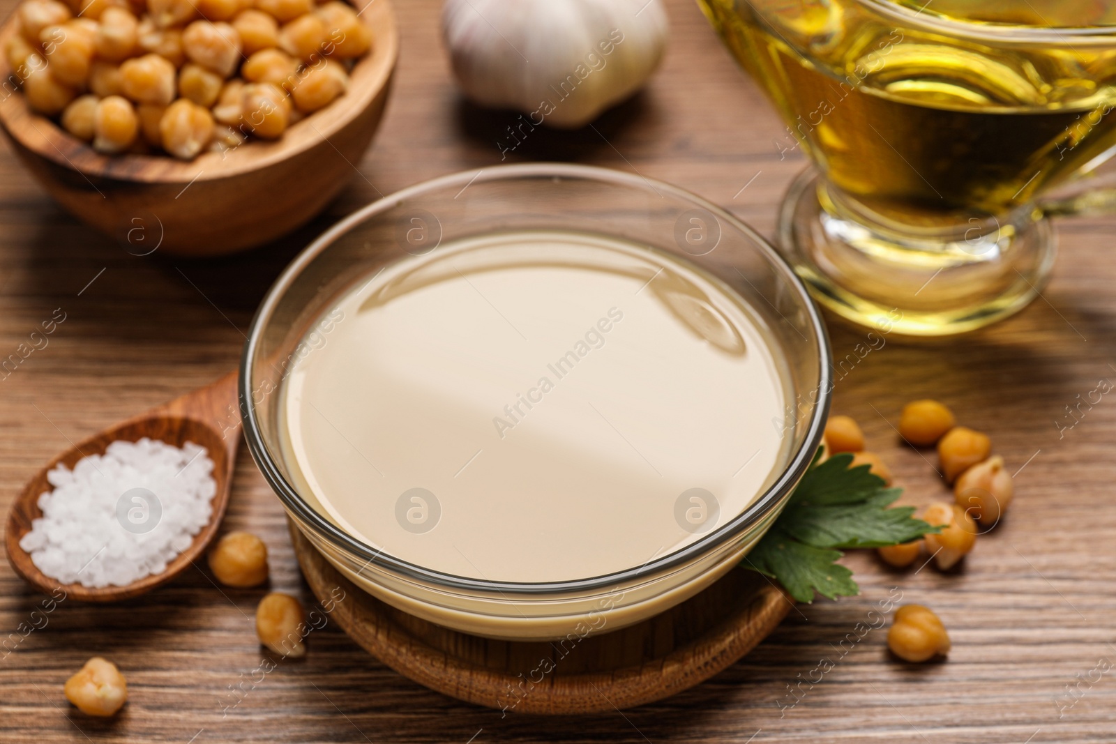 Photo of Different ingredients on wooden table. Cooking delicious hummus